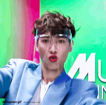 a gif of a man wearing a face shield and a blue jacket with the words atthaphan gif on the bottom