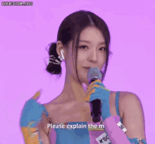 a woman in a colorful dress is holding a microphone .