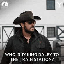 a man wearing a cowboy hat and sunglasses says who is taking daley to the train station ..
