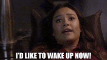 a woman is sitting in a chair with her eyes closed and the words `` i 'd like to wake up now '' .