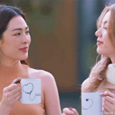 a woman holding a mug that says fashion on it
