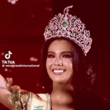 a tiktok of a woman wearing a crown that says missgrand international