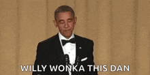 barack obama is wearing a tuxedo and tie and holding a microphone in his hand .