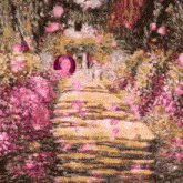 a woman is walking down a path surrounded by pink flowers and petals .