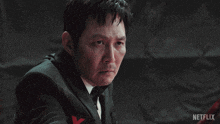 a man in a suit is holding a sword with netflix written on the bottom right
