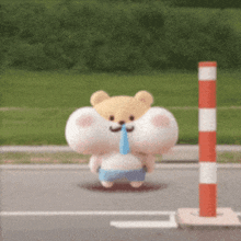 a stuffed animal with a mustache is walking down a street next to a pole .