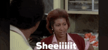 a woman is talking to a man in a kitchen and saying sheeiiiit .