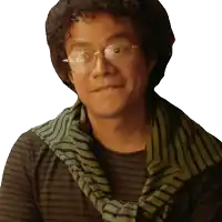 a man with curly hair wearing glasses and a green scarf around his neck