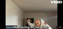 a man in a hoodie is dancing in a room with the words halal hoo reenacting bu_har_38469 on the screen
