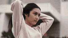 a woman in a white sweater has the name francine diaz at the bottom of the image