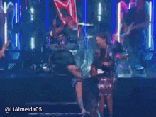 a group of people playing instruments on a stage with the hashtag lialmeida05 on the bottom