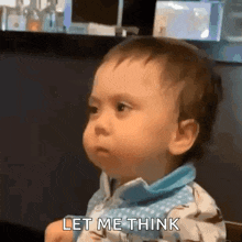 a baby is making a funny face and saying let me think