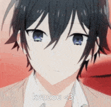 a close up of a black haired anime boy with blue eyes and the words `` kenzou < 3 '' written on his face .