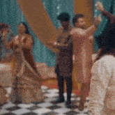 a group of people are dancing together in a room .