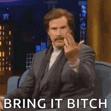 a man with a mustache is giving the middle finger and the words bring it bitch are below him