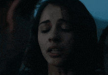 a close up of a woman 's face in the dark .