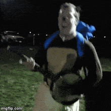 a man with a blue backpack is holding a banjo and smiling