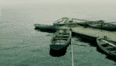 a row of boats are docked at a dock and one of them has the number 2 on it