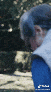 a blurred image of a person with tiktok written on the bottom