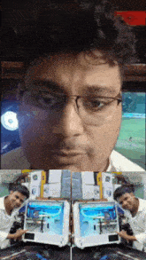 a man wearing glasses is looking at a computer monitor