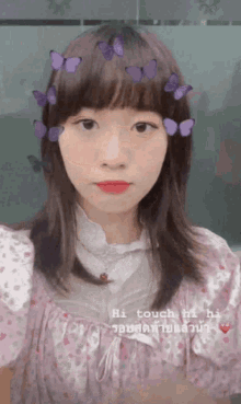 a girl with purple butterflies on her hair says hi touch hi ha