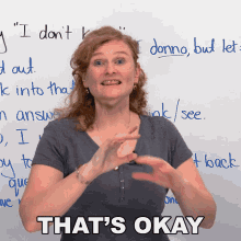 a woman in front of a white board says that 's okay