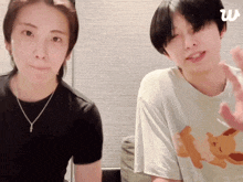 a man and a woman are sitting next to each other and one of them is wearing a shirt that says pokemon
