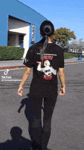 a woman wearing a black shirt that says helter