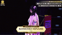 a female wrestler named komomo minami is on a screen