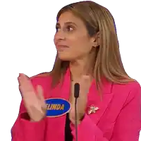 a woman wearing a pink jacket has a name tag that says linda on it