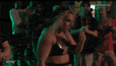 a female wrestler is standing in front of a green light with the words watchdpw on the bottom right
