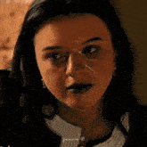 a close up of a woman 's face with a tear running down her face