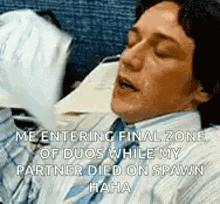 a man in a suit and tie is sleeping with his eyes closed while holding a piece of paper in his hand .