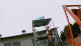 a person is standing in front of a building with a large explosion in the background .