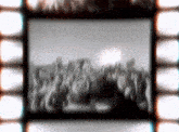 a blurred image of a crowd of people on a film strip