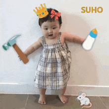 a baby wearing a crown and holding a hammer and a bottle with the word suho above her