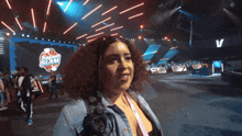 a woman standing in front of a sign that says slam