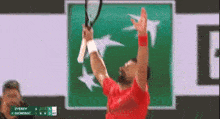 a man in a red shirt is swinging a tennis racquet in front of a bnp logo