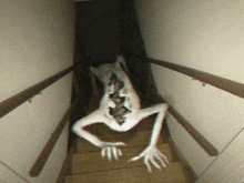 a monster is crawling up the stairs with its mouth open