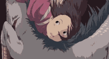 a girl is laying on the ground with a bird 's feathers .