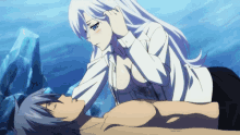 a man laying on the ground with a woman touching his ear