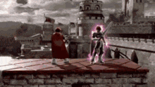 a man in a red cape is standing on top of a brick wall holding a sword .