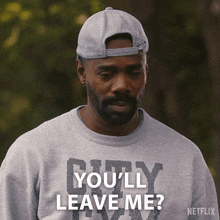 a man wearing a hat and a shirt that says you 'll leave me on it