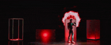 a man in a kamen rider costume stands in front of a red background