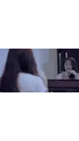 a woman is looking at her reflection in a bathroom mirror