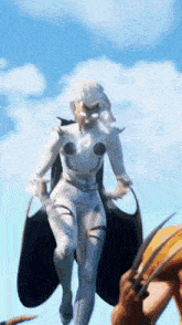 a woman in a white suit is standing next to a man with a sword .