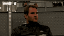 a man sits in a stadium watching a bt sport 3 live match