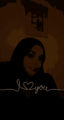 a woman in a dark room with the words i love you written on the bottom