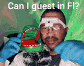 a man wearing blue gloves is holding a toy crocodile with the words can i guest in fl