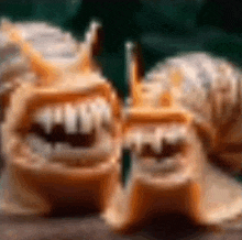 a blurred image of two pieces of bread with teeth and a green background